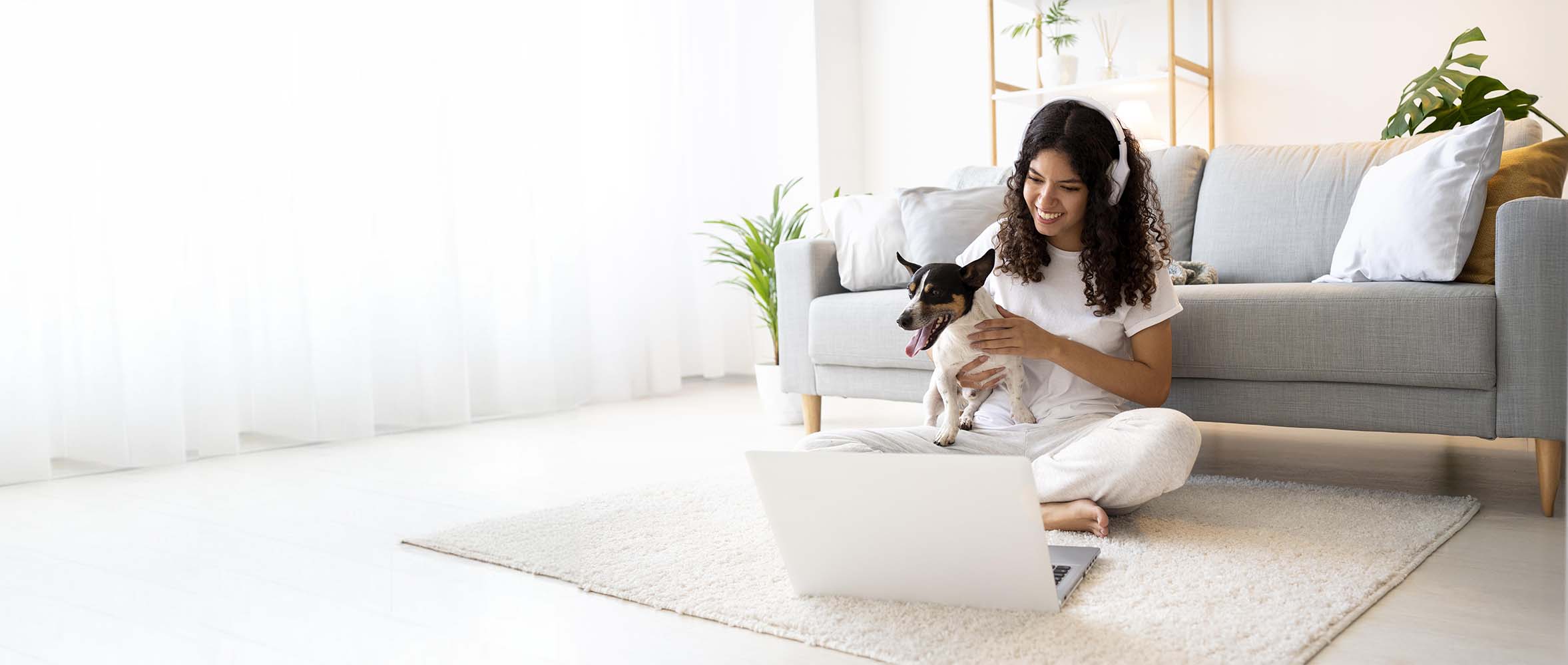 A young woman and her dog taking part attending an online class from FluentPet Academy.