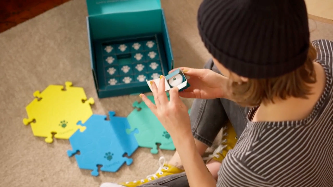 A young woman unboxing a FluentPet Kit.
