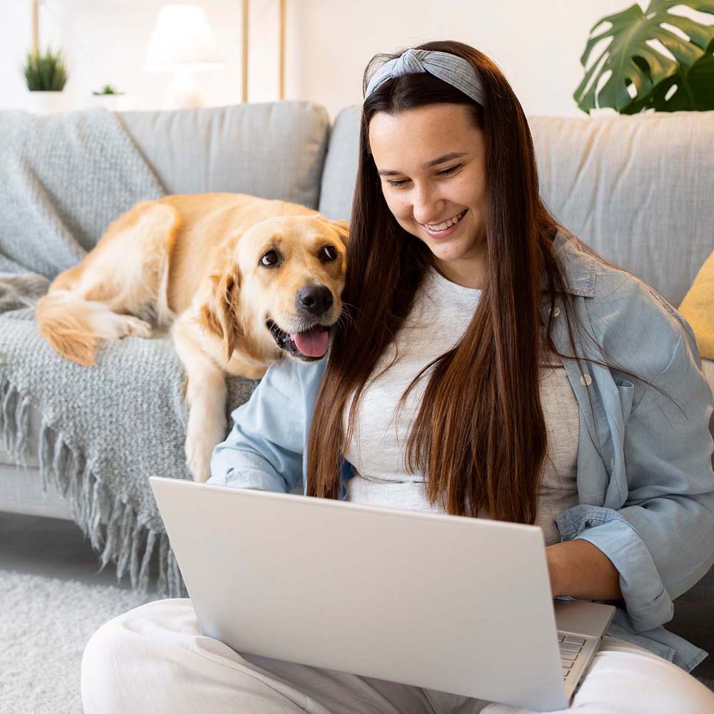 A young woman and her dog taking part in Button Bootcamp, FluentPet's online class.
