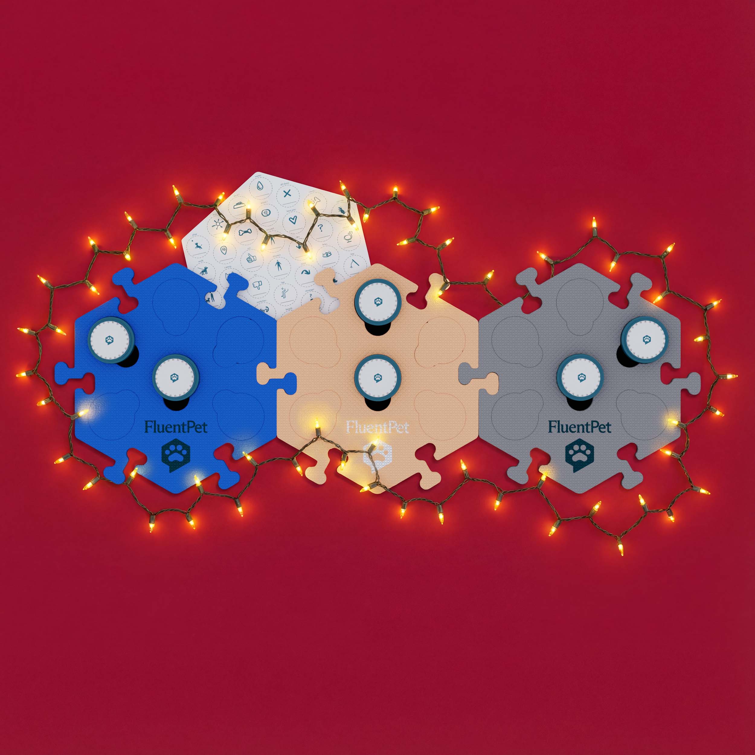Three FluentPet language system modules in blue, tan, and grey are adorned with glowing holiday lights on a rich red background, hinting at a Black Friday promo.