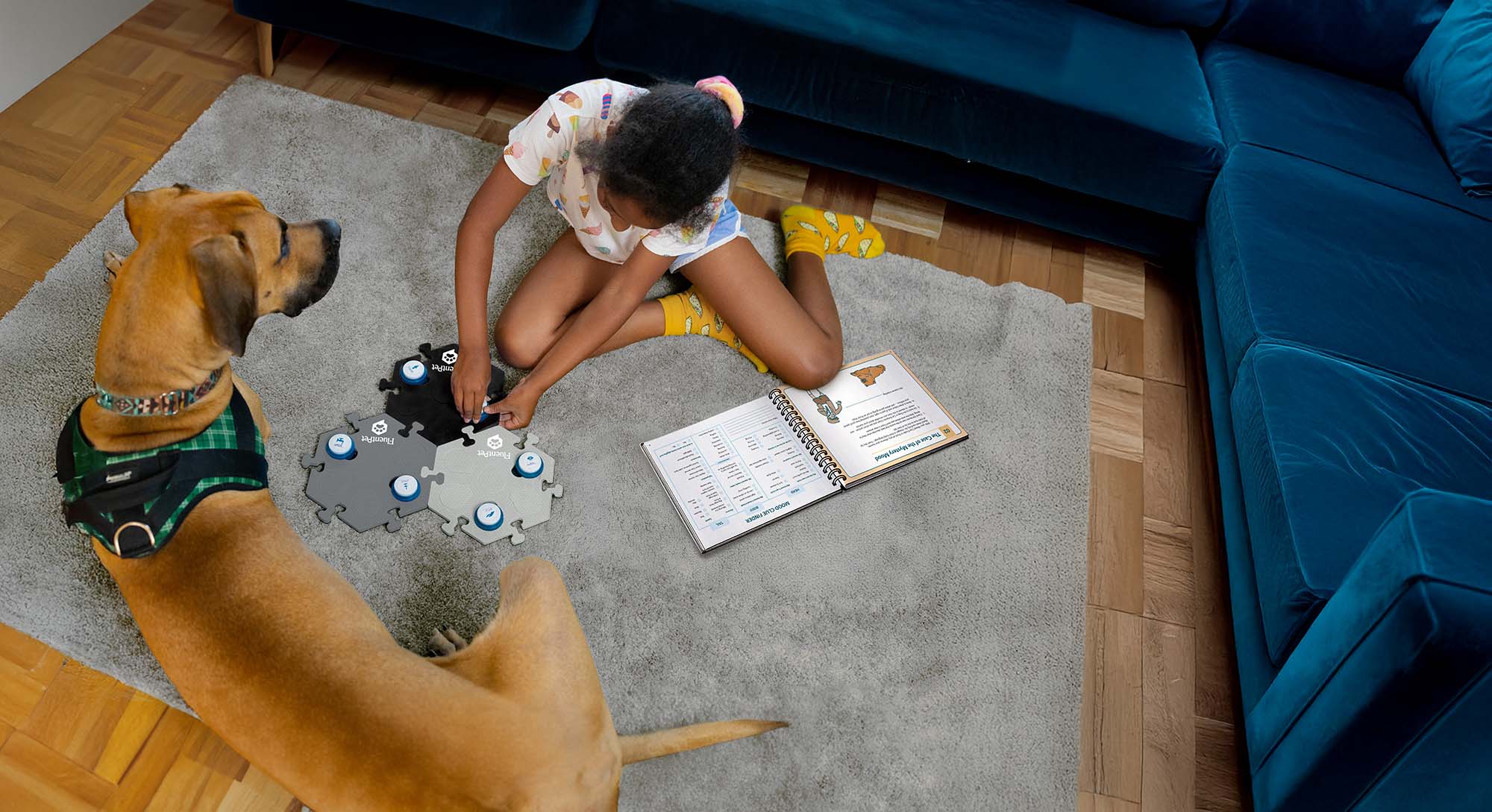 Young girl teaching her dog to talk with FluentPet Buttons